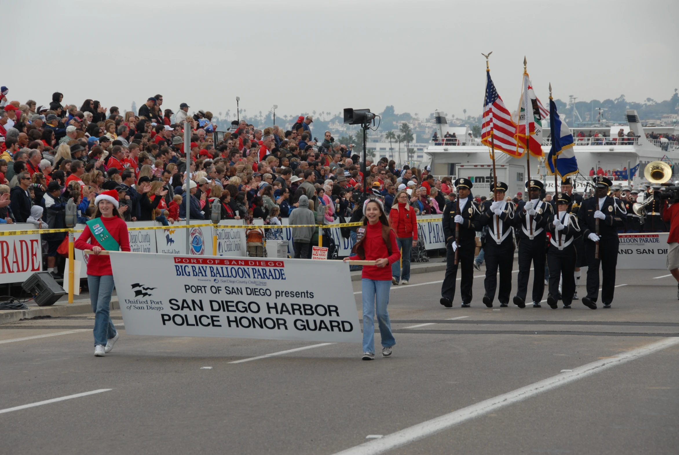 some people and a man in red are marching on the road