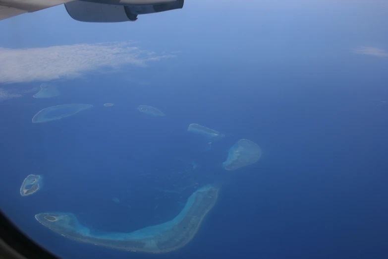 looking out an airplane window at some coral