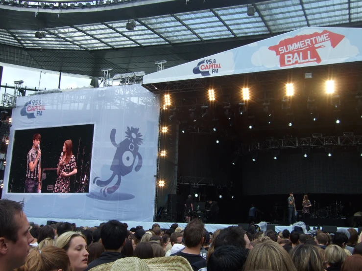 a person playing guitar on an empty stage