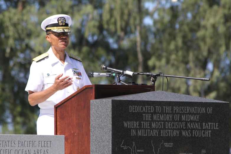 the military man is giving a speech at the podium