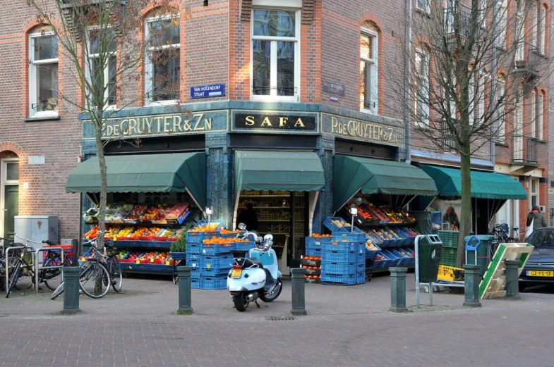 an outside area with a produce stand and a moped