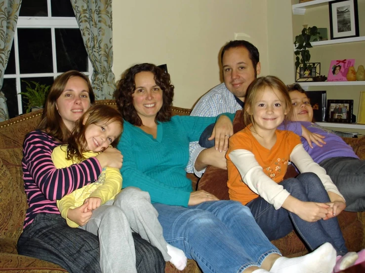 a family sits on the couch for a po