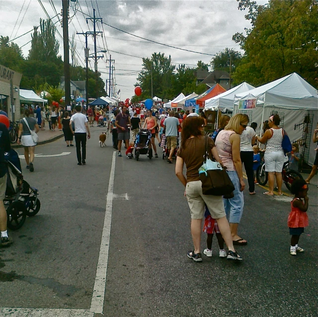 the group of people are enjoying the fair outside