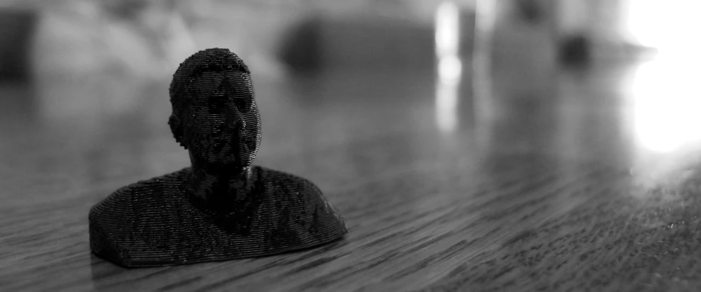 black and white pograph of a dummy on a wood table