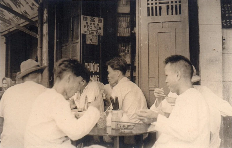 four men are sitting down and talking while drinking drinks