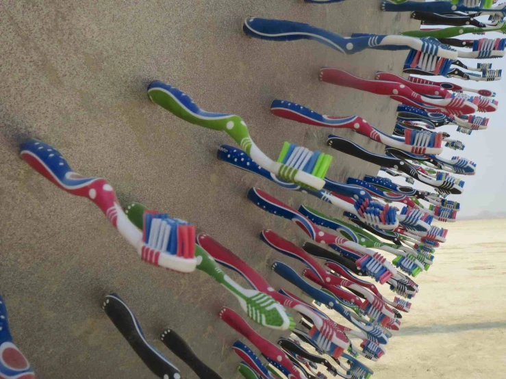 toothbrushes lined up against each other and the wall