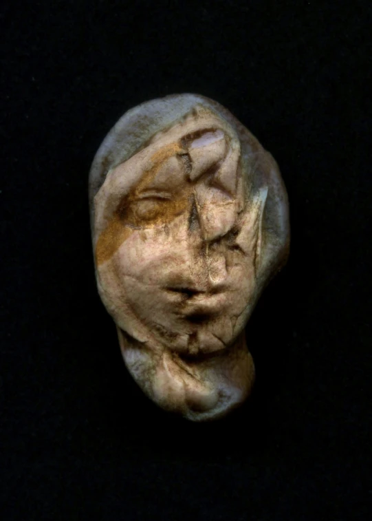 the head of a person in ceramic with hair on its head