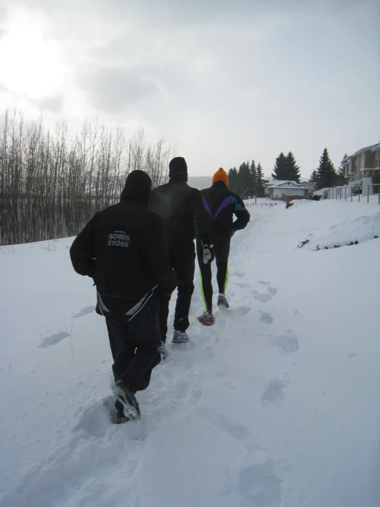 three people are going down the hill in ski gear