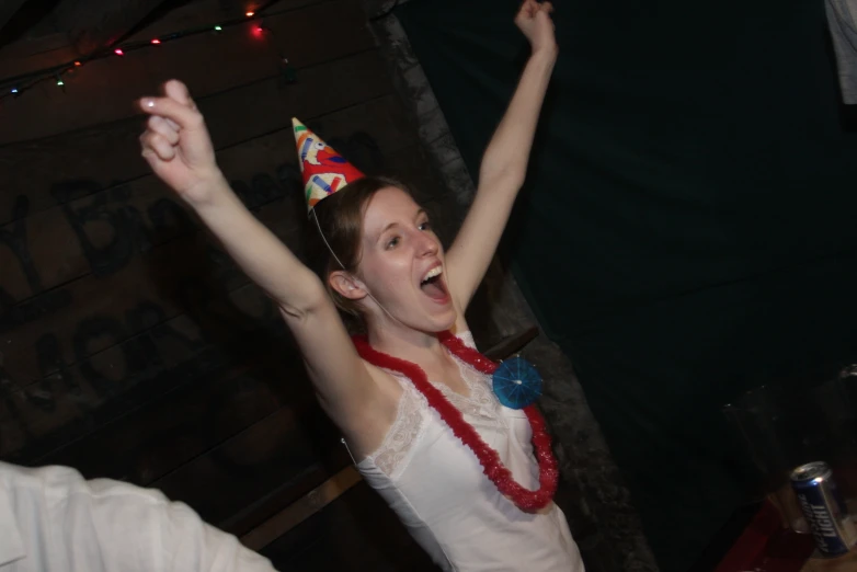 a young woman with a birthday hat on