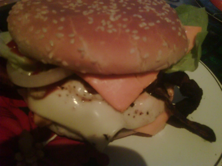 an egg and cheese burger sitting on a plate