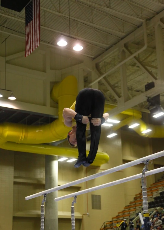 a man on a high bar performing tricks