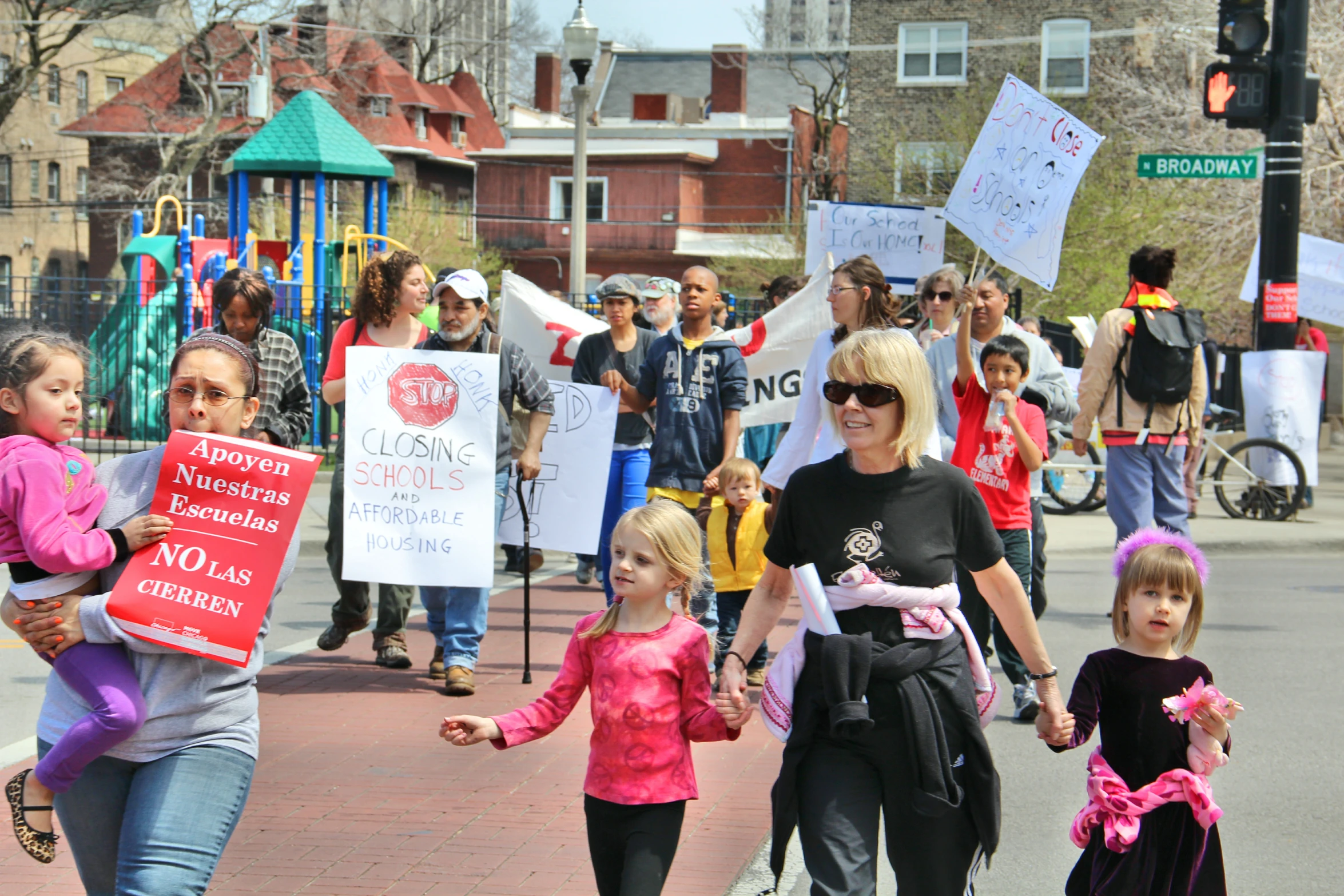 several women marching in a parade holding signs