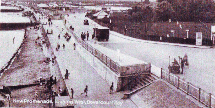 a view from the top of a bridge showing people walking across the street