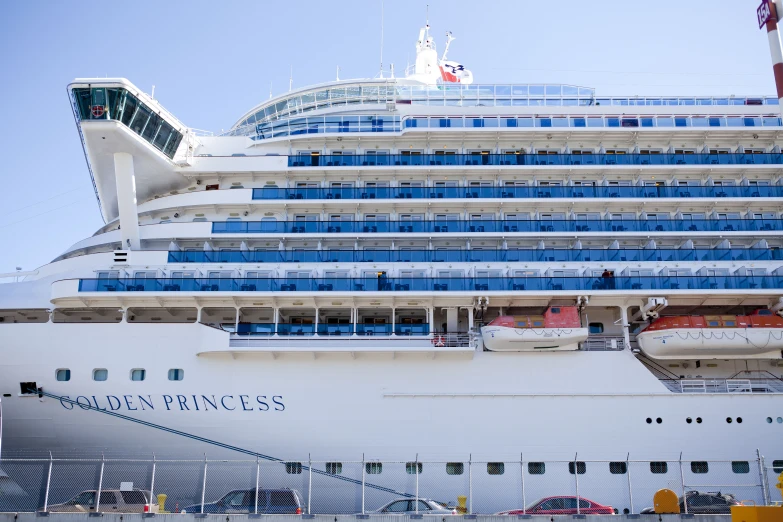 a cruise ship sits parked on the side of the street