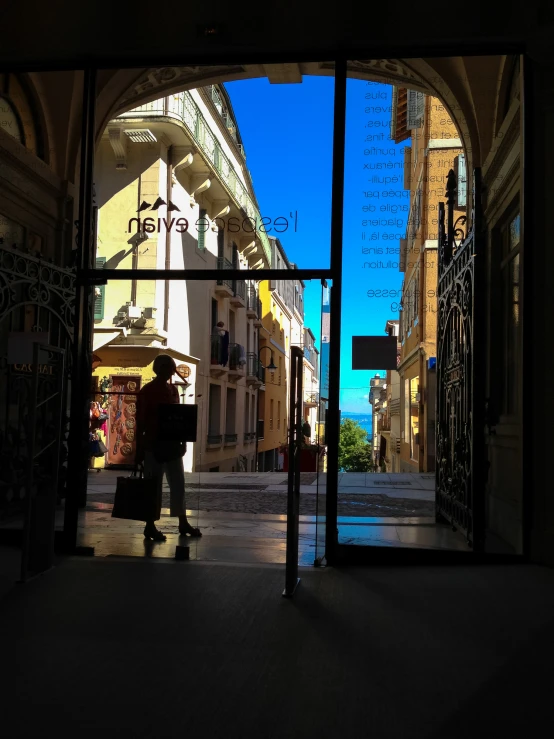 a person standing outside of a door holding an umbrella