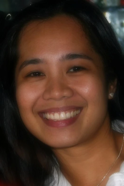 a girl in a red shirt smiles for the camera