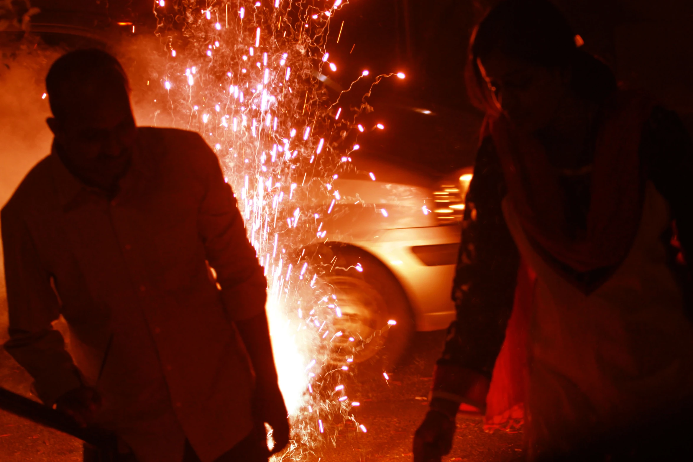 two people standing next to a fire hydrant