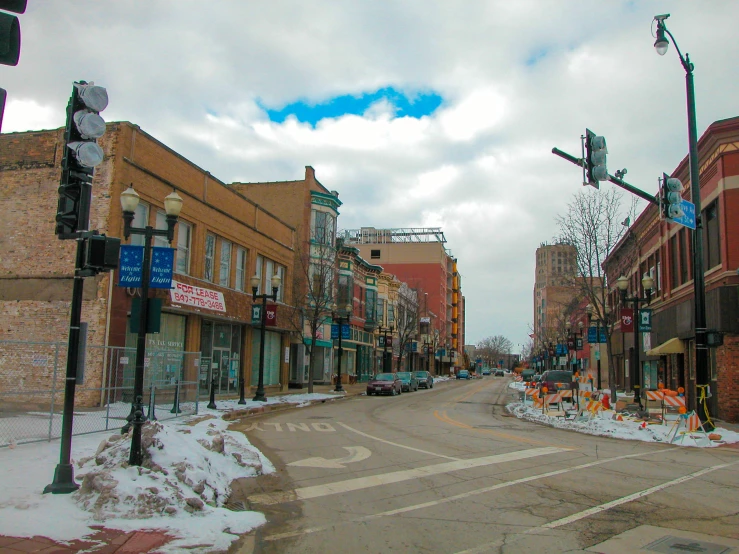 several shops along a street with snow on the ground