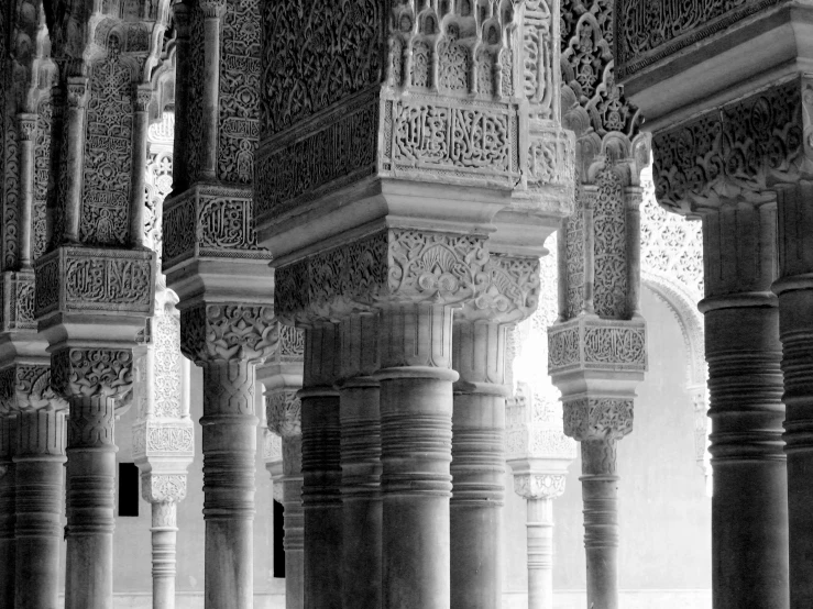 black and white pograph of pillars and walls in the interior of an old house