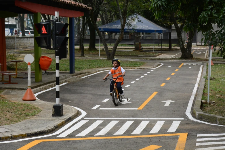 a child is riding his bike down the street