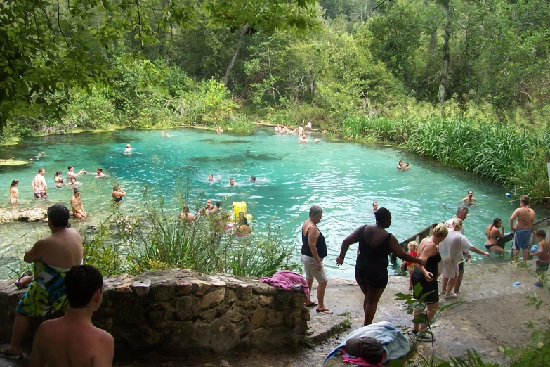 people swimming and bathing in the river