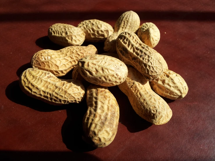 a close up of peanuts in the shell on a table