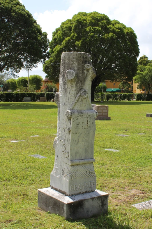 an odd looking monument in a field thats a cemetery