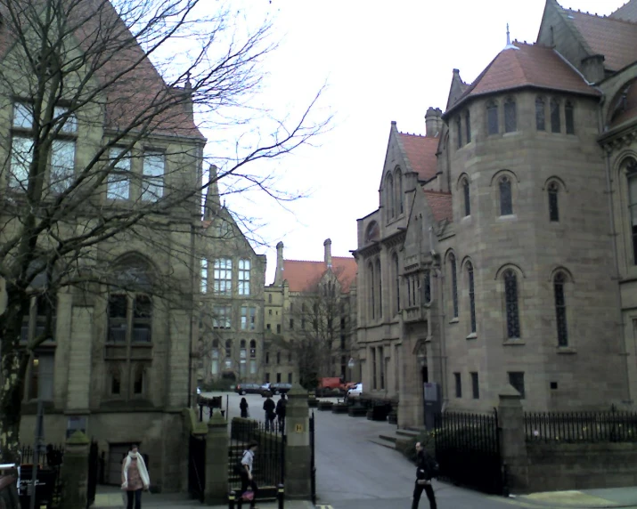 an old castle like building sitting on the side of a street