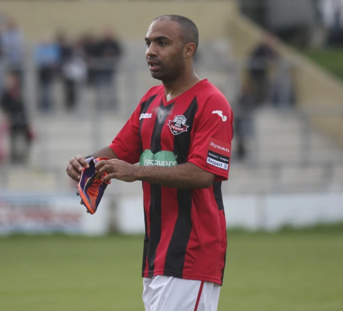 a man holding a soccer glove on a field