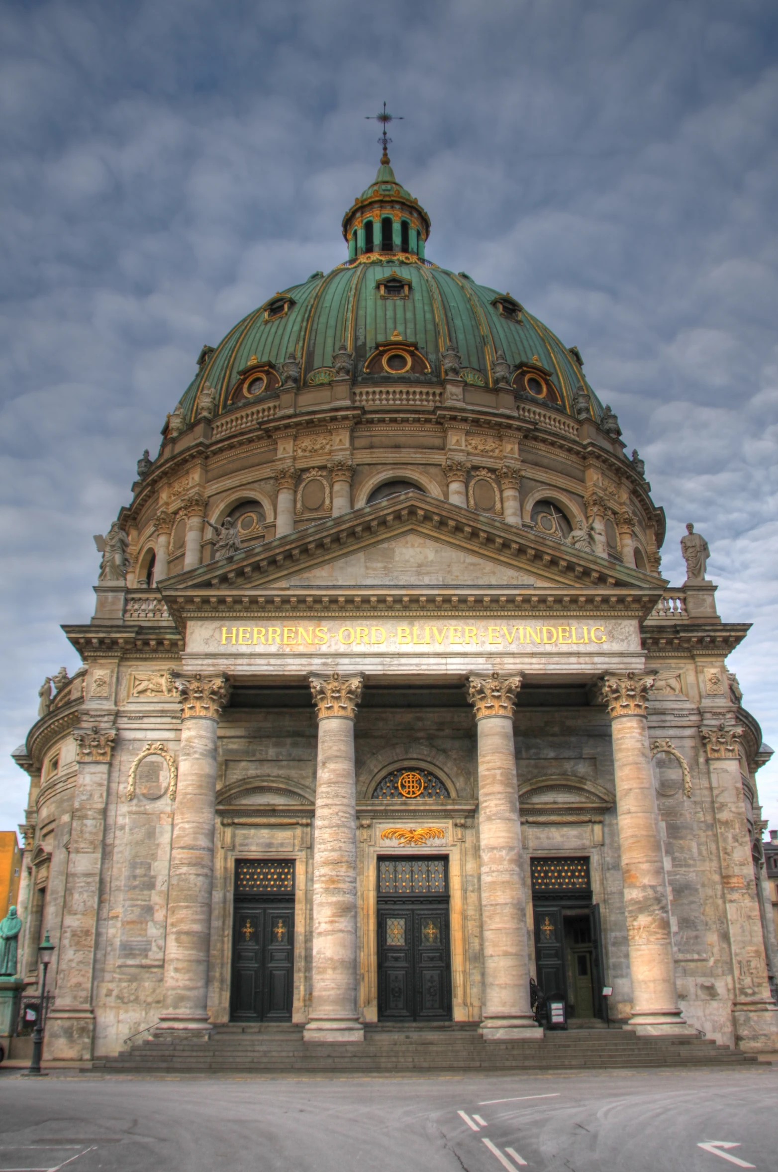 a large church with a large dome sits on a city street