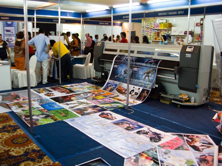 a group of people and a printer in a room