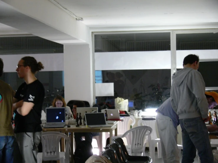 group of people standing in the living room of a house