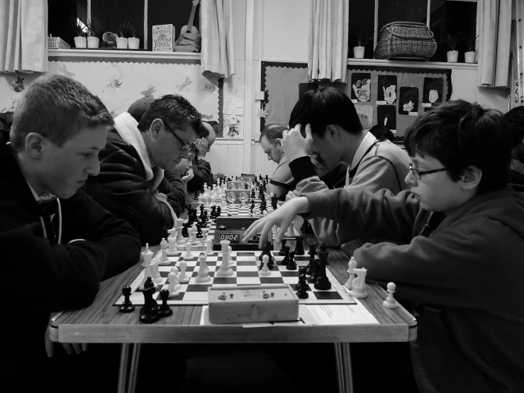 men play chess in an old room with their friends