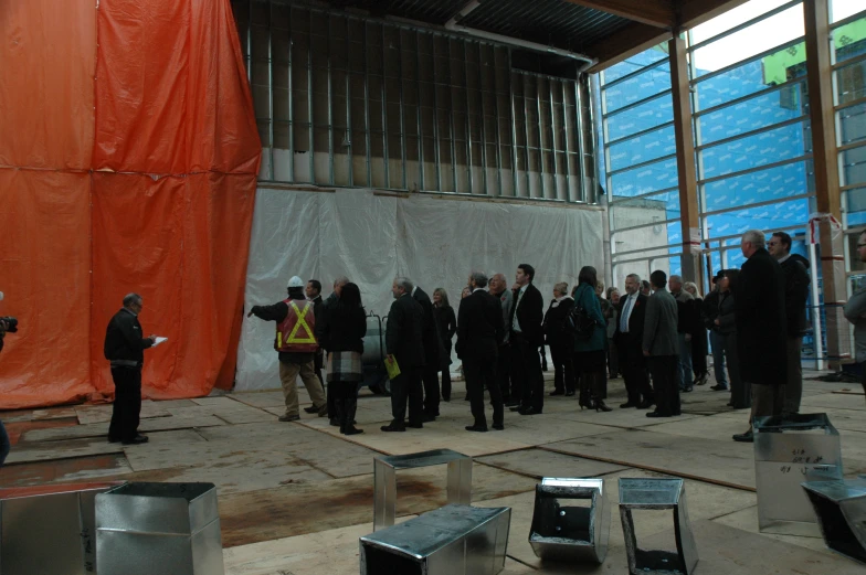 a group of people in suits are standing in front of a crowd