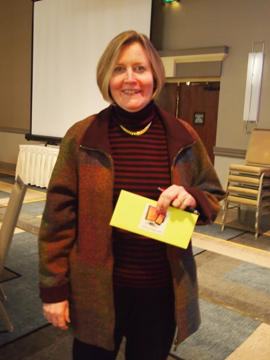 a woman holding up an empty yellow box