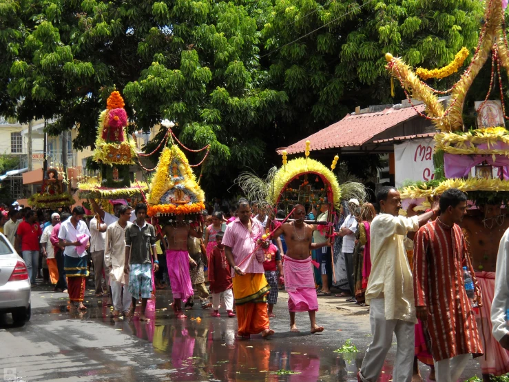 a crowd of people on the street with masks