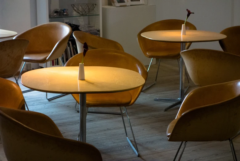 an array of chairs sitting at a table in front of books