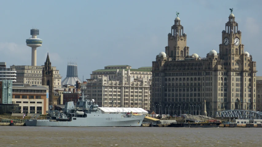 the large boat is near several old buildings