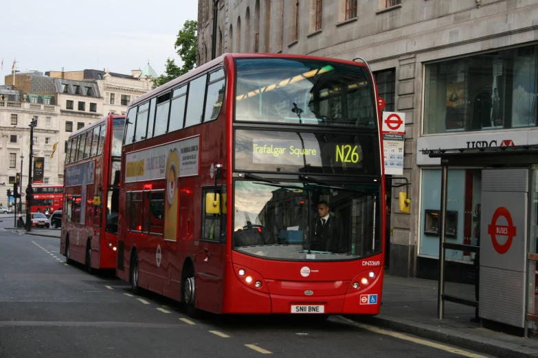 two double decker buses parked in front of buildings