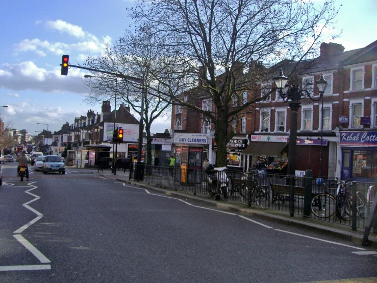 an empty city street has cars and buildings