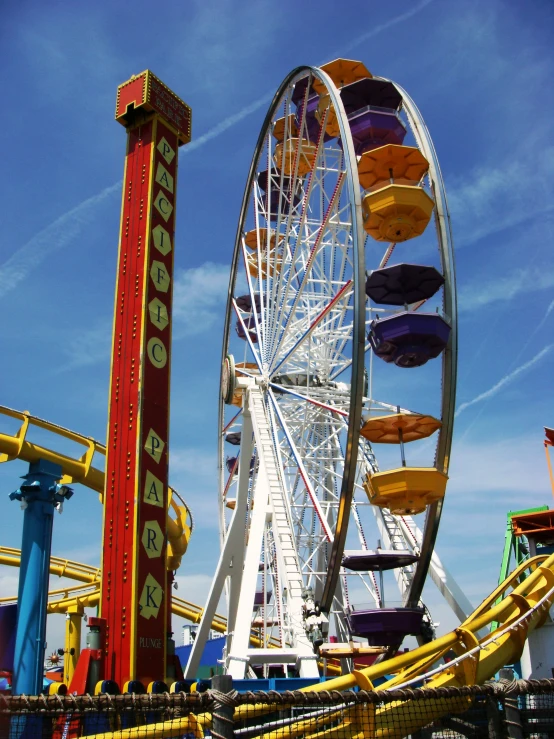 a ferris wheel, roller coaster and rides in an amut park