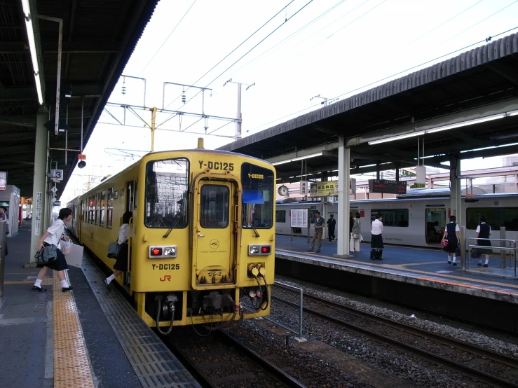 yellow train pulled up to the train station