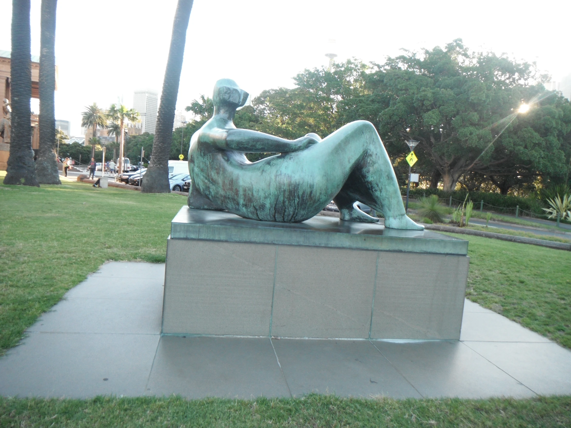 a statue of a person is sitting on a bench