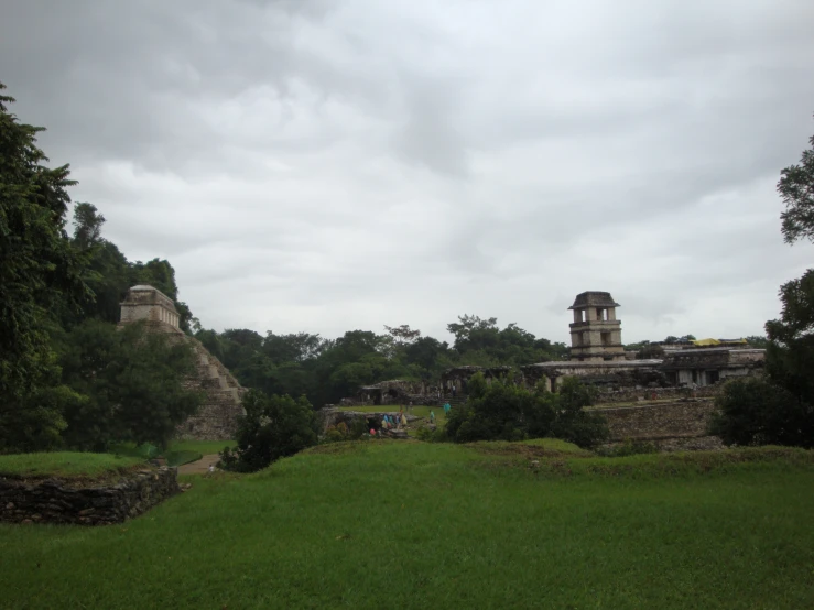 a group of buildings surrounded by forest on a hill