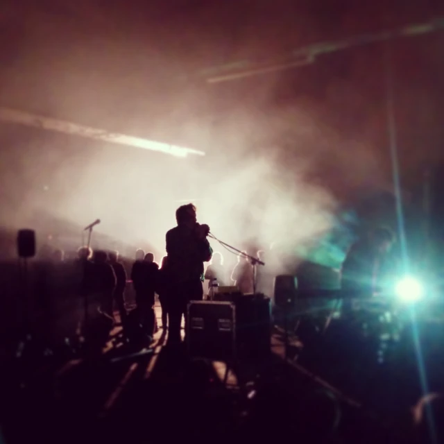 a crowd of people watching a band on stage