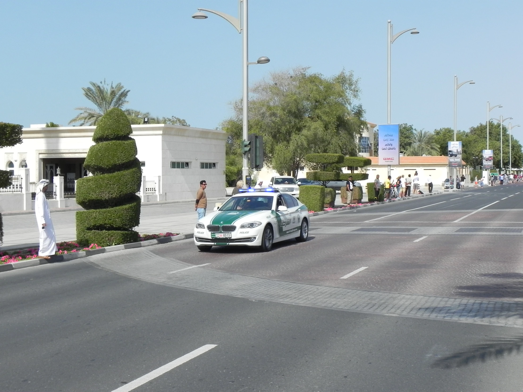 there is a police car that is going down the road