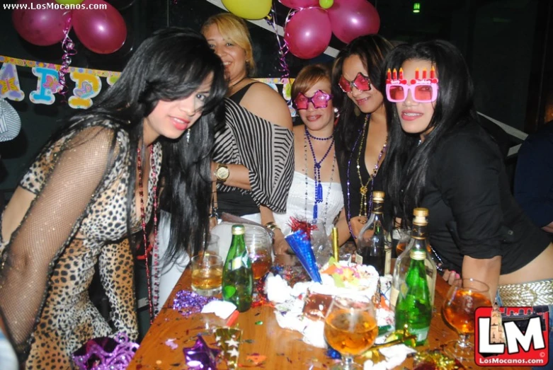 people wearing funny masks sit at a table