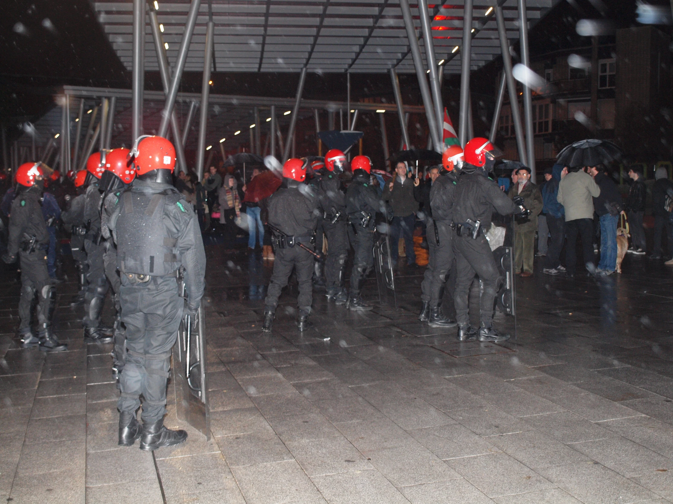 many people standing in line wearing hard hats