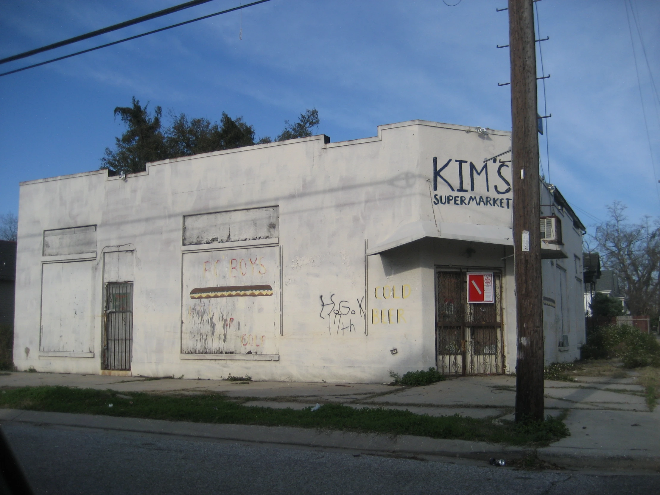 an old, white building with graffiti on it and an antenna pole