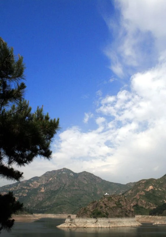 the view from the deck of a large lake with mountains in the distance